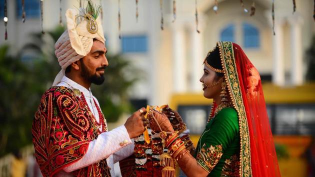A bride and a groom pose for a photograph ahead of a mass wedding ceremony in Surat, some 270 km from Ahmedabad, Gujarat. (Sam Panthaky / AFP) A bride and a groom pose for a photograph ahead of a mass wedding ceremony in Surat, some 270 km from Ahmedabad, Gujarat. (Sam Panthaky / AFP)