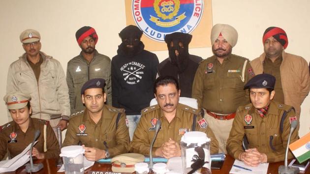 The accused (masked) in police custody in Ludhiana on Monday.(HT PHOTO)