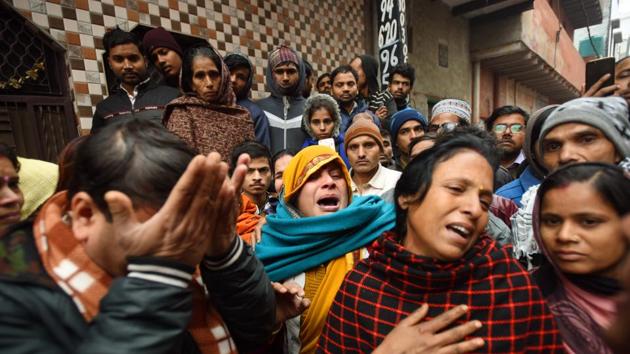 New Delhi, India - Dec. 23, 2019: Family members of the victims are seen outside the three storey residential-cum-commercial building where a fire broke out last night killing nine people, at Kirari, in New Delhi, India, on Monday, December 23, 2019. (Photo by Amal KS / Hindustan Times)(Amal KS/HT PHOTO) New Delhi, India - Dec. 23, 2019: Family members of the victims are seen outside the three storey residential-cum-commercial building where a fire broke out last night killing nine people, at Kirari, in New Delhi, India, on Monday, December 23, 2019. (Photo by Amal KS / Hindustan Times)(Amal KS/HT PHOTO)