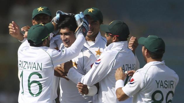 Pakistani players greet Naseem Shah after the dismissal of Sri Lankan batsman during the second Test in Karachi.(AP)