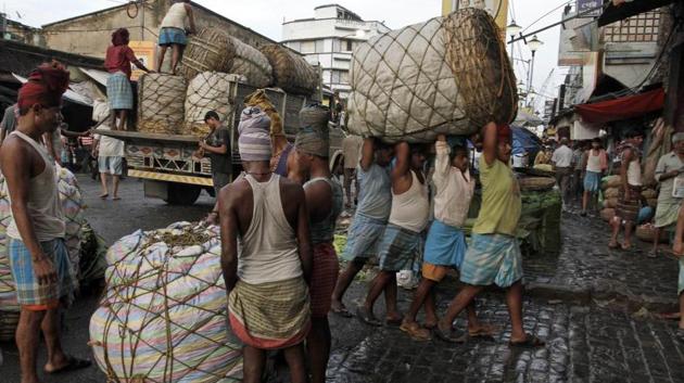 Indian laborers carry a giant basket of vegetables to a wholesale market in Kolkata, India. Image for representation(AP file photo)