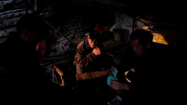 Fishermen play a game of poker in a tent . Residents blame the Three Gorges Project for the problems facing the lake, with its vast 660km-long reservoir storing huge volumes of water behind a giant dam for power generation. “The Three Gorges is blocking off all the water,” said Zhang Yingsheng, a 59-year old fisherman picking clams from the edge of the lake. “Every winter is like this now, but this year is especially low because of the drought.” (Aly Song / REUTERS) Fishermen play a game of poker in a tent . Residents blame the Three Gorges Project for the problems facing the lake, with its vast 660km-long reservoir storing huge volumes of water behind a giant dam for power generation. “The Three Gorges is blocking off all the water,” said Zhang Yingsheng, a 59-year old fisherman picking clams from the edge of the lake. “Every winter is like this now, but this year is especially low because of the drought.” (Aly Song / REUTERS)