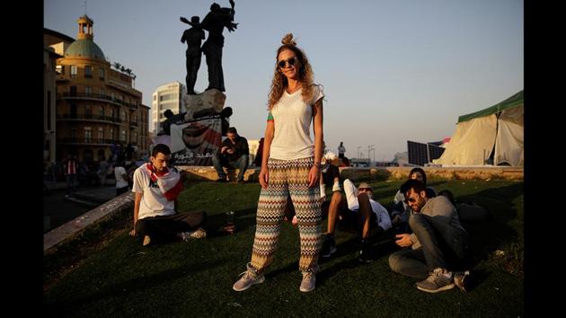 Hiba Ghosn, 36, who works in the fashion industry, with her friends, as people gather during anti-government protests in Beirut, Lebanon. “They are thieves, every single one of them. They’ve been robbing us for 30 years,” she said. “The new generation should come in and politicians that are more like us, and see what we see. I think it’s gonna take a very long time to reach there...but we will. I think we’ve woken up the dragon.” (Andres Martinez Casares / REUTERS) Hiba Ghosn, 36, who works in the fashion industry, with her friends, as people gather during anti-government protests in Beirut, Lebanon. “They are thieves, every single one of them. They’ve been robbing us for 30 years,” she said. “The new generation should come in and politicians that are more like us, and see what we see. I think it’s gonna take a very long time to reach there...but we will. I think we’ve woken up the dragon.” (Andres Martinez Casares / REUTERS)