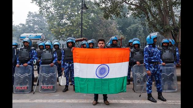 Mohammad Anas Qureshi, 20, a fruit vendor, with the national flag of India in front of riot police during a protest against the Citizenship Amendment Act in Delhi. “We are here to protest against the new citizenship law. This law is wrong against Muslims and India. It will divide the country. We won’t let it happen,” he said. “I think all the protesters all over the world are fighting for their rights.” (Danish Siddiqui / REUTERS) Mohammad Anas Qureshi, 20, a fruit vendor, with the national flag of India in front of riot police during a protest against the Citizenship Amendment Act in Delhi. “We are here to protest against the new citizenship law. This law is wrong against Muslims and India. It will divide the country. We won’t let it happen,” he said. “I think all the protesters all over the world are fighting for their rights.” (Danish Siddiqui / REUTERS)