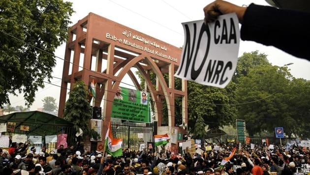 Protestors hold placards as they attend a protest against the Citizenship Amendment Act 2019 and NRC at Jamia Millia Islamia in New Delhi.(Photo: ANI)