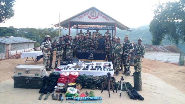 BSF officers display the arms and ammunition recovered in Aizawl.