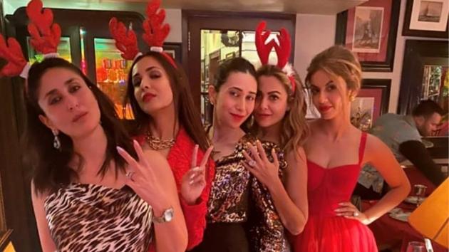 Kareena looked stunning in an animal print jumpsuit and her cute red antlers, while sister Karisma Kapoor almost twinned with her in her animal print top with black pants. Malaika Arora wore a festive red pantsuit, while sister Amrita Arora wore a glittering, sequinned grey jumpsuit. Natasha Poonawalla wore a gorgeous, flared red tulle dress. (INSTAGRAM) Kareena looked stunning in an animal print jumpsuit and her cute red antlers, while sister Karisma Kapoor almost twinned with her in her animal print top with black pants. Malaika Arora wore a festive red pantsuit, while sister Amrita Arora wore a glittering, sequinned grey jumpsuit. Natasha Poonawalla wore a gorgeous, flared red tulle dress. (INSTAGRAM)