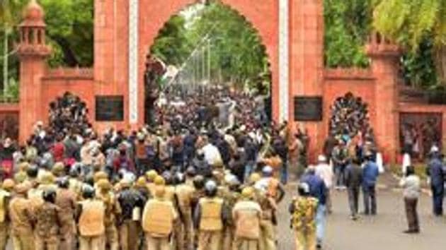 Police personnel stand guard outside Aligarh Muslim University (AMU) as students protest against the passing of Citizenship Amendment Bill.(PTI Photo) Police personnel stand guard outside Aligarh Muslim University (AMU) as students protest against the passing of Citizenship Amendment Bill.(PTI Photo)