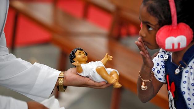 A girl is presented a figure of baby Jesus at a church during Christmas celebrations in Ahmedabad, Gujarat. (Amit Dave / REUTERS) A girl is presented a figure of baby Jesus at a church during Christmas celebrations in Ahmedabad, Gujarat. (Amit Dave / REUTERS)
