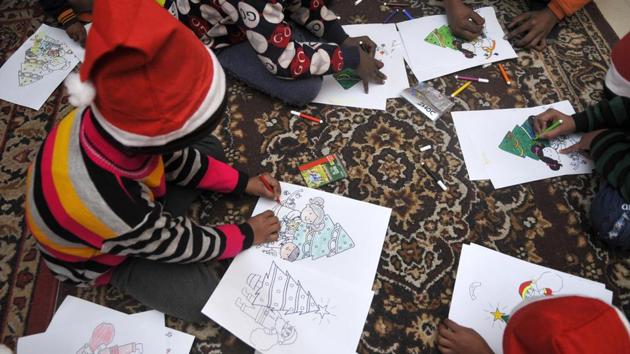 Children colour Christmas trees during an event organised by an NGO in an orphanage on the Christmas Eve, at Sector 92 in Noida, Uttar Pradesh. (Sunil Ghosh / HT Photo) Children colour Christmas trees during an event organised by an NGO in an orphanage on the Christmas Eve, at Sector 92 in Noida, Uttar Pradesh. (Sunil Ghosh / HT Photo)