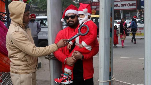 A man and a child dressed as Santa Claus undergo security checks during Christmas celebrations in Chandigarh. (Ajay Verma / REUTERS) A man and a child dressed as Santa Claus undergo security checks during Christmas celebrations in Chandigarh. (Ajay Verma / REUTERS)