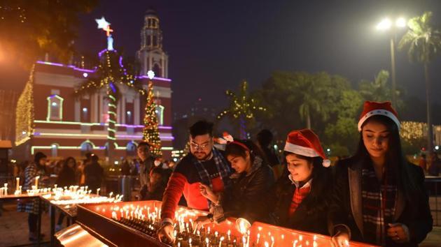 People light candles on the eve of Christmas at Sacred Heart Cathedral Church in New Delhi. People braved the biting cold and continued air pollution in the city to participate in the festivities. (Sanchit Khanna / HT Photo) People light candles on the eve of Christmas at Sacred Heart Cathedral Church in New Delhi. People braved the biting cold and continued air pollution in the city to participate in the festivities. (Sanchit Khanna / HT Photo)