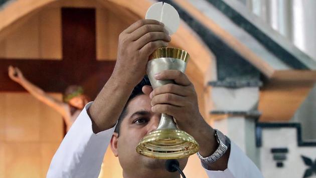 A priest holds a chalice and the Eucharist at a prayer session inside a church during Christmas celebrations in Kolkata, West Bengal. (Rupak De Chowdhuri / REUTERS) A priest holds a chalice and the Eucharist at a prayer session inside a church during Christmas celebrations in Kolkata, West Bengal. (Rupak De Chowdhuri / REUTERS)