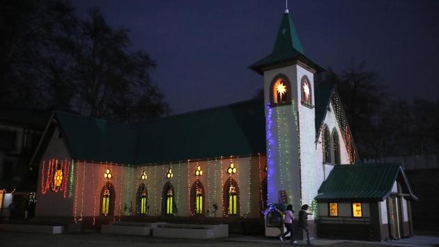 Worshippers walk towards the Holy Family Catholic church on Christmas Eve in Srinagar. (Mukhtar Khan / AP) Worshippers walk towards the Holy Family Catholic church on Christmas Eve in Srinagar. (Mukhtar Khan / AP)