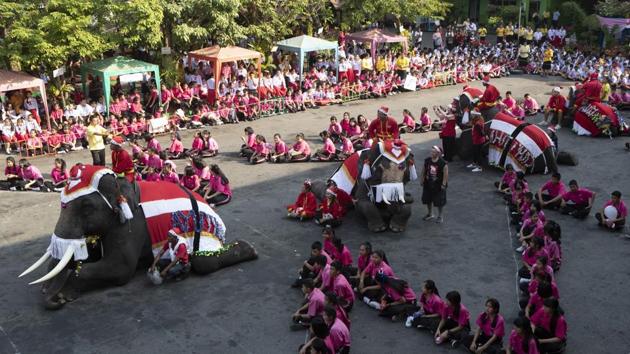 Elephants dressed in Santa Claus costumes sit with students at the Jirasartwitthaya school during Christmas celebrations in Ayutthaya province. (AP)