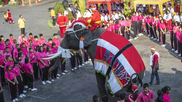 An elephant dressed in a Santa Claus costume performs in front of students at Jirasartwitthaya school during Christmas celebrations in Ayutthaya province north of Bangkok, Thailand. The annual event is held every year for to celebrate the upcoming Christmas. (AP)