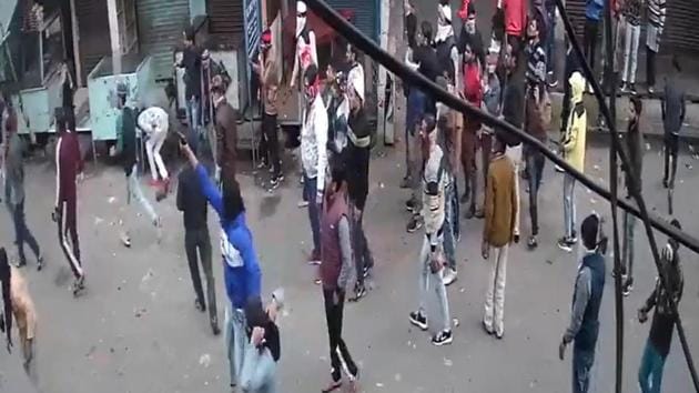 A grab from the video shard by UP Police which shows a masked man in a blue jacket walking around with a gun. A grab from the video shard by UP Police which shows a masked man in a blue jacket walking around with a gun.