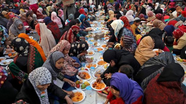 Local residents break their day-long fast as they attend a protest against the Citizenship Amendment Act (CAA), at Shaheen Bagh in New Delhi. Hundreds of men, women and children, have occupied the stretch of road at the area to protest against the CAA and National Register of Citizens (NRC), reports Reuters. (Anushree Fadnavis / REUTERS)