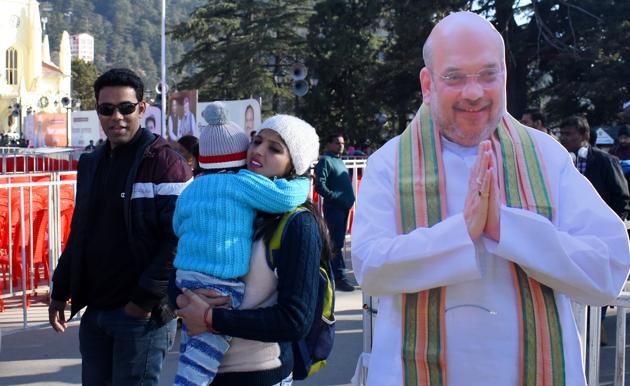 Tourists pose with the poster of Union Home Minister Amit Shah at the Ridge in Shimla. He was at the Himachal Pradesh capital on Friday at a rally to mark two years of BJP rule in the state. (Deepak Sansta / Hindustan Times) Tourists pose with the poster of Union Home Minister Amit Shah at the Ridge in Shimla. He was at the Himachal Pradesh capital on Friday at a rally to mark two years of BJP rule in the state. (Deepak Sansta / Hindustan Times)