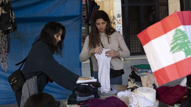 Volunteers sort donated clothing for the needy in a tent near Martyrs' Square. AP reports that campaigns to collect food, winter clothes and helplines for people in economic and emotional distress are popping up everywhere, intensified by the Christmas spirit. (Maya Alleruzzo / AP) Volunteers sort donated clothing for the needy in a tent near Martyrs' Square. AP reports that campaigns to collect food, winter clothes and helplines for people in economic and emotional distress are popping up everywhere, intensified by the Christmas spirit. (Maya Alleruzzo / AP)