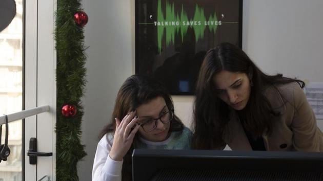 Volunteers Farah, left, and Saha, wait for calls at Lebanon’s Embrace, a mental health organisation operating the national suicide prevention helpline in Beirut. AP reports that the helpline now receives 100 calls a week, up from up to 10 before reports of suicides or attempted suicides erupted three weeks ago. According to Mia Atwi, clinical psychologist and founder of the organisation, the protests have created a unique experience — “something for everybody,” whether they support or oppose the revolt. (Maya Alleruzzo / AP) Volunteers Farah, left, and Saha, wait for calls at Lebanon’s Embrace, a mental health organisation operating the national suicide prevention helpline in Beirut. AP reports that the helpline now receives 100 calls a week, up from up to 10 before reports of suicides or attempted suicides erupted three weeks ago. According to Mia Atwi, clinical psychologist and founder of the organisation, the protests have created a unique experience — “something for everybody,” whether they support or oppose the revolt. (Maya Alleruzzo / AP)