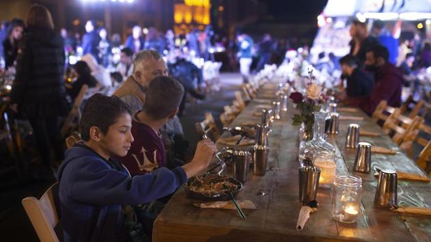 A boy eats with his brother and father at a public Christmas dinner. “Our relations are built on humanity and national unity,” Mohamed Shkeir, a 23-year-old architect student, who, along with friends launched a campaign appealing for donations, told AP. Their group has given money, food, clothes and supplies to 58 families so far this month, including one family reduced to using candles because they can’t afford electricity. “Our friendships are built on helping people,” he added. (Maya Alleruzzo / AP) A boy eats with his brother and father at a public Christmas dinner. “Our relations are built on humanity and national unity,” Mohamed Shkeir, a 23-year-old architect student, who, along with friends launched a campaign appealing for donations, told AP. Their group has given money, food, clothes and supplies to 58 families so far this month, including one family reduced to using candles because they can’t afford electricity. “Our friendships are built on helping people,” he added. (Maya Alleruzzo / AP)