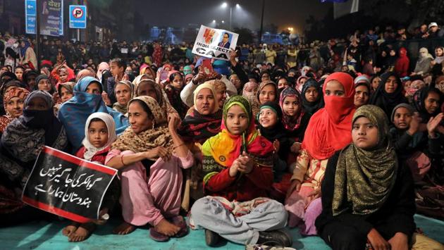 Local residents are seen holding placards during the protest. The country has been witnessing demonstrations since December 12, after the government enacted the CAA that provides non-Muslim minorities from Afghanistan, Bangladesh and Pakistan who moved here before 2015, a pathway to Indian citizenship. (Anushree Fadnavis / REUTERS)