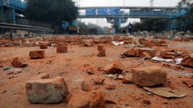 Pieces of bricks lay scattered on a road during the protest. (Anushree Fadnavis / REUTERS)