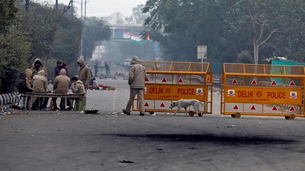 Police officers sit around a bonfire to keep themselves warm next to a barricade during a protest. Deputy Commissioner of Police Chinmoy Biswal told Reuters that he was negotiating with protesters, and was hopeful the site would empty out soon as local support for the demonstration waned. (Anushree Fadnavis / REUTERS)