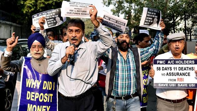 PMC Bank depositors hold placards and shout slogans during a protest march outside Reserve bank of India, in New Delhi.(ANI Photo)