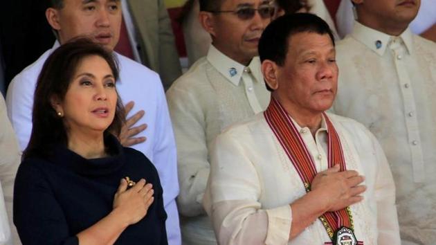 President Rodrigo Duterte and Vice-President Leni Robredo stand at attention for the national anthem during the Philippine National Police Academy graduation ceremony in Camp Castaneda. Duerte’s deadly war on drugs -- backed by many Filipinos but condemned by critics who say it is a war crime -- has claimed at least 5,500 lives, however, watchdogs say the actual toll is at least four times higher.(REUTERS) President Rodrigo Duterte and Vice-President Leni Robredo stand at attention for the national anthem during the Philippine National Police Academy graduation ceremony in Camp Castaneda. Duerte’s deadly war on drugs -- backed by many Filipinos but condemned by critics who say it is a war crime -- has claimed at least 5,500 lives, however, watchdogs say the actual toll is at least four times higher.(REUTERS)