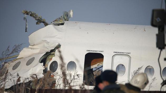 Emergency and security personnel are seen at the site of a plane crash near Almaty, Kazakhstan.(REUTERS) Emergency and security personnel are seen at the site of a plane crash near Almaty, Kazakhstan.(REUTERS)