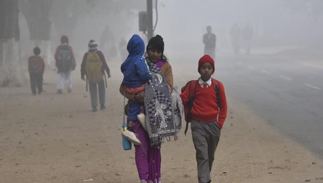 Students on a way to school during a cold and foggy morning(HT File)