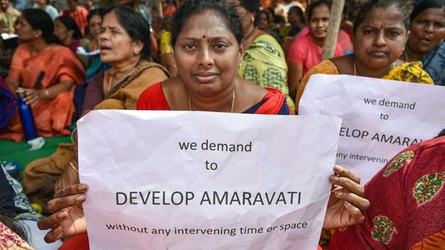 Farmers hold placards as they protest against the three capital cities for the state proposed by Andhra Pradesh Chief Minister YS Jaganmohan Reddy, at Thullur village in Guntur.(PTI)