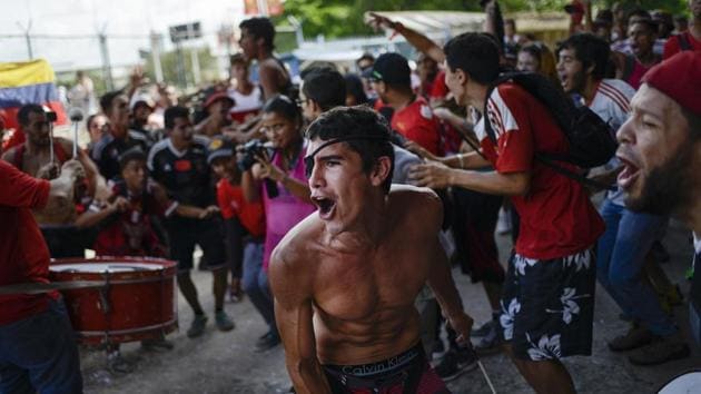 David Osorio, member of the Caracas FC fan club, sings and plays a drum before a Copa Sudamerica soccer match between his team and Ecuador's Independiente del Valle at Estadio Olímpico in Caracas. The fans, who call themselves the ‘Red Demons,’ don't care that most of their compatriots prefer baseball or that their team has a bad season. (Matias Delacroix / AP)