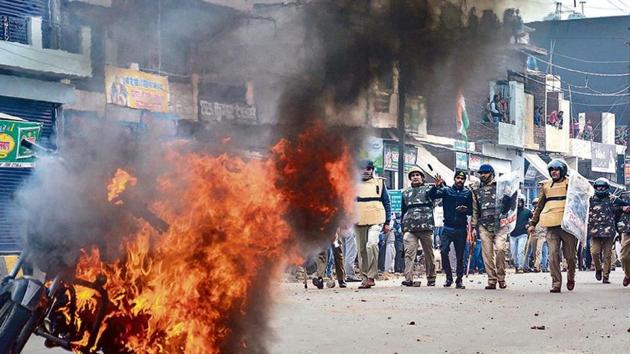 Smoke rises from a burning vehicle during a protest against the CAA in Muzaffarnagar(PTI) Smoke rises from a burning vehicle during a protest against the CAA in Muzaffarnagar(PTI)