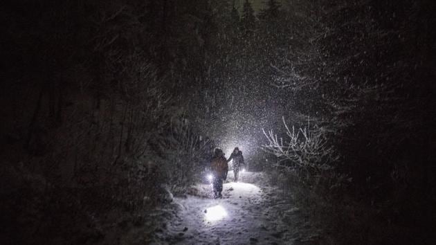 A group of refugees walk their way under a blizzard as they attempt to enter the EU through Croatia in the mountains surrounding the town of Bihac, northwestern Bosnia. Bosnia’s notorious Vucjak camp may have closed down after an international outcry, but the plight of migrants stranded in the country while trying to reach Western Europe is far from over. (Manu Brabo / AP) A group of refugees walk their way under a blizzard as they attempt to enter the EU through Croatia in the mountains surrounding the town of Bihac, northwestern Bosnia. Bosnia’s notorious Vucjak camp may have closed down after an international outcry, but the plight of migrants stranded in the country while trying to reach Western Europe is far from over. (Manu Brabo / AP)