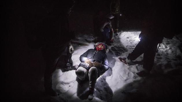 Indian migrant Nishademi, 22, lies exhausted on the snow near the Croatian border. The tent camp was flattened earlier this month, its residents transferred to other parts of Bosnia. Yet they are making their way back to Bihac because it is closest to the place they want to get to — Bosnia’s neighbor, EU member Croatia. (Manu Brabo / AP) Indian migrant Nishademi, 22, lies exhausted on the snow near the Croatian border. The tent camp was flattened earlier this month, its residents transferred to other parts of Bosnia. Yet they are making their way back to Bihac because it is closest to the place they want to get to — Bosnia’s neighbor, EU member Croatia. (Manu Brabo / AP)