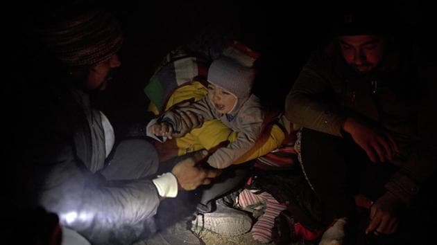 Omar, 1, a Syrian refugee from Aleppo, cries while his mother Fatma, 24, comforts him. It’s toughest for families with small children. Babies can’t stop crying. Parents bring the children as close to the fire as possible to keep them warm, but they are tired and the severe cold nonetheless bites at their tiny faces. (Manu Brabo / AP) Omar, 1, a Syrian refugee from Aleppo, cries while his mother Fatma, 24, comforts him. It’s toughest for families with small children. Babies can’t stop crying. Parents bring the children as close to the fire as possible to keep them warm, but they are tired and the severe cold nonetheless bites at their tiny faces. (Manu Brabo / AP)