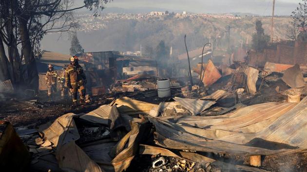 Firefighters walk into the scene of a fire in Valparaiso, Chile. More than 245 homes were destroyed and 700 people left destitute after a forest fire tore through the Chilean seaside city of Valparaiso on Christmas Eve. (Rodrigo Garrido / REUTERS) Firefighters walk into the scene of a fire in Valparaiso, Chile. More than 245 homes were destroyed and 700 people left destitute after a forest fire tore through the Chilean seaside city of Valparaiso on Christmas Eve. (Rodrigo Garrido / REUTERS)