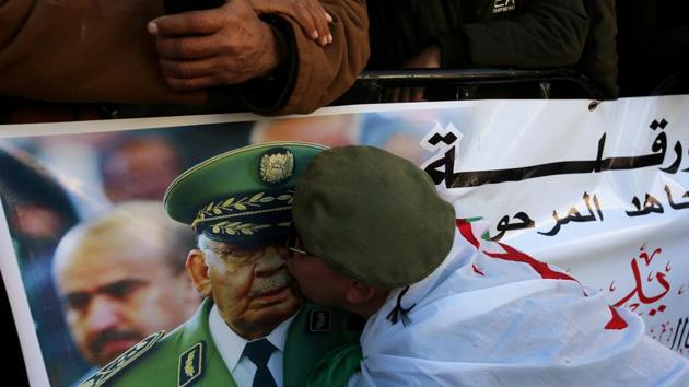 A participant kisses the image of Lieutenant General Ahmed Gaed Salah on a banner as people gather outside the Palace of the People during the funeral of the late Algeria’s military chief in Algiers, Algeria. (Ramzi Boudina / REUTERS) A participant kisses the image of Lieutenant General Ahmed Gaed Salah on a banner as people gather outside the Palace of the People during the funeral of the late Algeria’s military chief in Algiers, Algeria. (Ramzi Boudina / REUTERS)