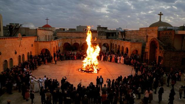 Iraqi Christians gather around a fire as they attend a mass on Christmas Eve at the Grand Immaculate Church in al-Hamdaniya, near Mosul, Iraq. (Abdullah Rashid / REUTERS) Iraqi Christians gather around a fire as they attend a mass on Christmas Eve at the Grand Immaculate Church in al-Hamdaniya, near Mosul, Iraq. (Abdullah Rashid / REUTERS)