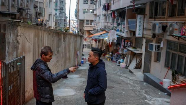 District councillor Lee Yue-Shun (right) talks with a local who built a temple without permission from the local council. "I think there are also specific challenges in each district. For me it is really hard to really get along with the Fujian community because they have a very different historical and cultural background and I take a really long time to build a network and rapport in that community. I think that is the greatest challenge for me," said Yue-Shun. (Thomas Peter / REUTERS) District councillor Lee Yue-Shun (right) talks with a local who built a temple without permission from the local council. "I think there are also specific challenges in each district. For me it is really hard to really get along with the Fujian community because they have a very different historical and cultural background and I take a really long time to build a network and rapport in that community. I think that is the greatest challenge for me," said Yue-Shun. (Thomas Peter / REUTERS)