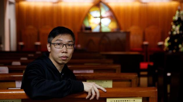 Pastor David Lau poses for a photo in a church that holds services in the Minnan language that is common in Fujian, at North Point. "I can feel the tension between different groups," said Lau. "I think for some people they don't believe the government is wrong so I am challenging them to think differently." But he said he has toned down his language since July and now focuses his sermons on asking his community to "love people that you may not like." (Thomas Peter / REUTERS) Pastor David Lau poses for a photo in a church that holds services in the Minnan language that is common in Fujian, at North Point. "I can feel the tension between different groups," said Lau. "I think for some people they don't believe the government is wrong so I am challenging them to think differently." But he said he has toned down his language since July and now focuses his sermons on asking his community to "love people that you may not like." (Thomas Peter / REUTERS)