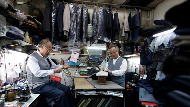 Tailors Tsang Siu Man, 78, and his brother Tsang Sik Lang, 63, work in their store underneath the State Theatre Building. Born and raised in North Point, the Tsang brothers opened their store selling handmade suits in the building in 1993. “We barely make enough to cover the rent, even though the rent is cheap, business is slow.” he said. (Thomas Peter / REUTERS) Tailors Tsang Siu Man, 78, and his brother Tsang Sik Lang, 63, work in their store underneath the State Theatre Building. Born and raised in North Point, the Tsang brothers opened their store selling handmade suits in the building in 1993. “We barely make enough to cover the rent, even though the rent is cheap, business is slow.” he said. (Thomas Peter / REUTERS)