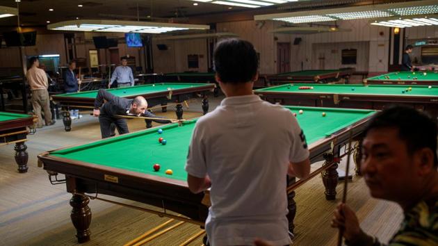 Men play snooker in the State Theatre Building. During anti-government demonstrations in Hong Kong this year, North Point was the scene of street brawls between men in white T-shirts - believed to be pro-Beijing supporters – and black-clad protesters. But the neighbourhood unexpectedly switched sides during elections to the District Council. (Thomas Peter / REUTERS) Men play snooker in the State Theatre Building. During anti-government demonstrations in Hong Kong this year, North Point was the scene of street brawls between men in white T-shirts - believed to be pro-Beijing supporters – and black-clad protesters. But the neighbourhood unexpectedly switched sides during elections to the District Council. (Thomas Peter / REUTERS)