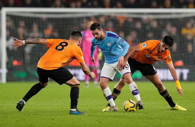 Soccer Football - Premier League - Wolverhampton Wanderers v Manchester City - Molineux Stadium, Wolverhampton, Britain - December 27, 2019 Wolverhampton Wanderers' Raul Jimenez and Ruben Neves in action with Manchester City's Bernardo Silva REUTERS/Andrew Yates(REUTERS)