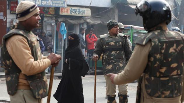 A woman walks past policemen in riot gear on a street in Meerut, Uttar Pradesh. Image used for representational purpose only.(Photo: Reuters) A woman walks past policemen in riot gear on a street in Meerut, Uttar Pradesh. Image used for representational purpose only.(Photo: Reuters)