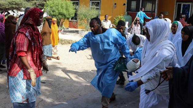 Nurses carry a person who was wounded during a car bombing attack, at the Madina Hospital in Mogadishu, Somalia. A massive car bomb exploded in a busy area of Mogadishu on December 28 leaving at least 76 people dead, many of them university students. (Abdirazak Hussein Farah / AFP) Nurses carry a person who was wounded during a car bombing attack, at the Madina Hospital in Mogadishu, Somalia. A massive car bomb exploded in a busy area of Mogadishu on December 28 leaving at least 76 people dead, many of them university students. (Abdirazak Hussein Farah / AFP)