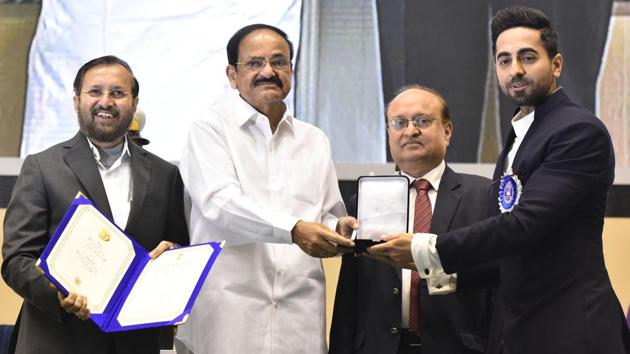 Vice President Venkaiah Naidu with Minister of Information and Broadcasting Prakash Javadekar and Secretary Ministry of Information and Broadcasting Ravi Mittal present the Best Actor award to Ayushmann Khurrana for his performance in the movie Andhadhun, during the 66th National Film Awards 2018, at Vigyan Bhawan in New Delhi. (Sonu Mehta / HT Photo)